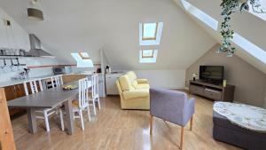 a kitchen and living room with a table and chairs at Le Voyageur A la plage vue mer in Berck-sur-Mer