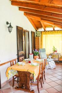 a wooden table and chairs in a room with a table at Piccola Oasi in Cannobio