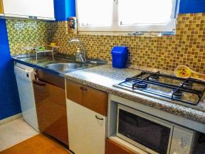 a kitchen with a sink and a stove at Piccola Oasi in Cannobio +15 photos