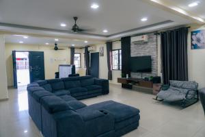 a large living room with couches and a tv at Green Villa Bukit Tinggi#event house#karaokeroom#swimmingpool in Klang