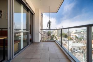 a balcony with a view of a city at Urban Nest Yaavetz Tlv in Tel Aviv