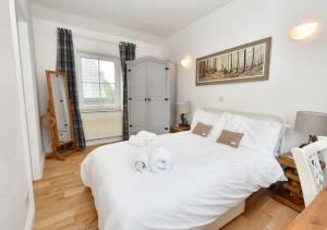 a bedroom with a white bed with towels on it at Bowland Breaks - Cobble View Cottage Cosy Retreat, Parking, Near Wedding Venues, Village Location with 3 great pubs in Waddington