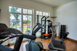 a gym with two treadmills and exercise bikes at Sunday Schwielowsee Resort - Hotel in Werder