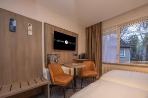 TV a/nebo společenská místnost v ubytování Fletcher Parkhotel Val Monte