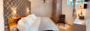 a bedroom with a bed and a desk in it at Au refuge du spéléo in Hotton