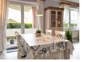 a dining room with a white table and chairs at Goosbrink Wohnung 13 in Boltenhagen