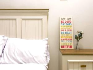 Una cama con una almohada blanca y un cartel en la pared. en 2BR Downtown Alia Khan, Fully equipped Gem, en El Cairo