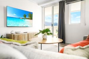 a living room with a view of the ocean at Cairns Central Apartment 1011 in Cairns