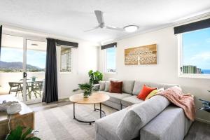 a living room with a couch and a table at Cairns Central Apartment 1011 in Cairns