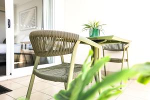a chair and a desk in a room at Cairns Central Studio 1012 Rooftop Shared Pool & CBD Location in Cairns