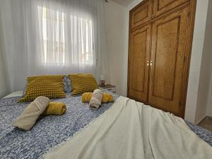 a bedroom with a bed with pillows on it at Elizabeth Apartment La Mata in La Mata +31 photos