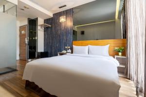 a large white bed in a hotel room at CHECK inn Express Taichung FuXing Hall 2 in Taichung +29 photos