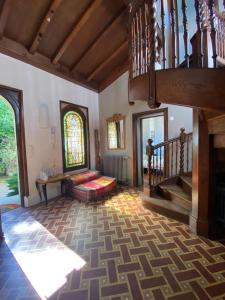 a living room with a staircase and a couch at VILLA BIARRITZ 1923 private pool in Biarritz