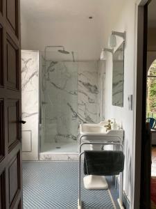 a white bathroom with a sink and a shower at VILLA BIARRITZ 1923 private pool in Biarritz