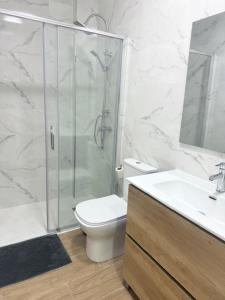 a bathroom with a shower and a toilet and a sink at guadiaro studio in Málaga