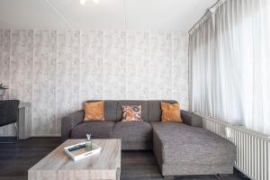 a living room with a couch and a coffee table at Beach Appartement 14 - Aan de duinen, Callantsoog aan Zee in Callantsoog
