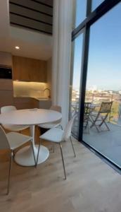 a room with a table and chairs on a balcony at NEW Douro 901 Mezzanini with parking in Vila Nova de Gaia