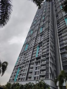 a tall building with palm trees in front of it at Trion KL Residence by Skyline in Kuala Lumpur +39 photos