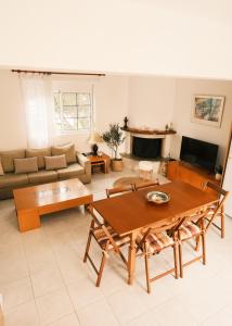 a living room with a table and a couch at Villa Anastasia in Apolakkiá