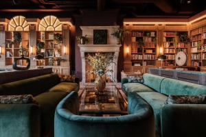 a living room with blue couches and a fireplace at Villa Foresta in Lidingö
