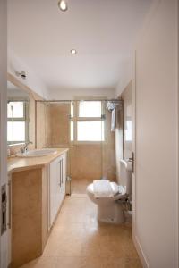 a bathroom with a toilet and a sink at VESTA - El Gouna Residence in Hurghada +23 photos