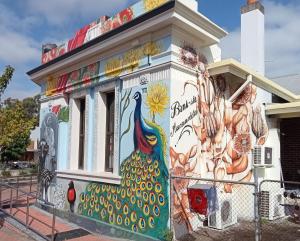 a building with a mural of a peacock on it at Bank-sia accommodation in Mount Barker +1 photo