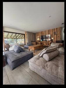a large room with two beds and a flat screen tv at Villa des châteaux du Pessac leognan in Martillac