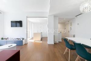 a living room and dining room with a table and chairs at HomeSweetHome Valencia in Valencia