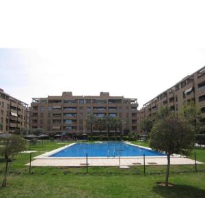 a large swimming pool in front of some buildings at HomeSweetHome Valencia in Valencia
