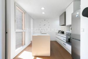 a kitchen with a white counter and a window at HomeSweetHome Valencia in Valencia