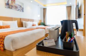 A bed or beds in a room at Hotel Anuttara