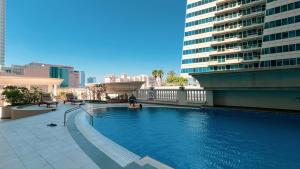 a large swimming pool in the middle of a building at Prime Location - 2BR with Spectacular Sea View in Dubai