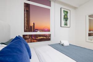 a bedroom with a window with a view of a city at Prime Location - 2BR with Spectacular Sea View in Dubai