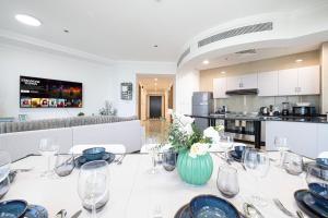 a dining room with a table with a vase of flowers at Prime Location - 2BR with Spectacular Sea View in Dubai