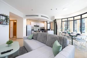 a living room with a couch and a table at Prime Location - 2BR with Spectacular Sea View in Dubai