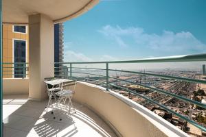 a balcony with a table and a view of a city at Prime Location - 2BR with Spectacular Sea View in Dubai