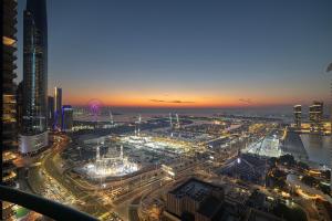 a view of a city at night at Prime Location - 2BR with Spectacular Sea View in Dubai