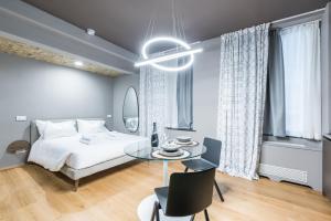 a bedroom with a bed and a table and chairs at Unique design 200 steps from the Aquarium in Genova