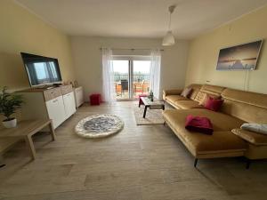 a living room with a couch and a television at Villa Damian in Umag