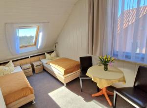 una piccola stanza con un letto e un tavolo di Pension Am Kirschberg a Weimar