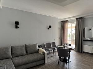 a living room with a couch and a table at Friendly House in Jurmala in Jūrmala