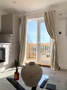 a living room with a large window with a balcony at Kaoglen - Alpine Pod - Hot Tub - Cairngorms - Pitlochry in Kirkmichael