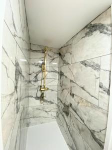 a bathroom with marble walls and a shower at Kaoglen - Alpine Pod - Hot Tub - Cairngorms - Pitlochry in Kirkmichael +55 photos
