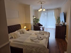 a hotel room with a bed with towels on it at Willa Atena in Świnoujście