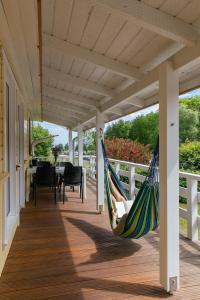 a hammock on the porch of a house at Bungalows Ostseequelle in Hohenkirchen
