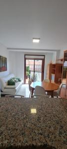 a living room with a couch and a table at Apartamentos Corea in Portonovo