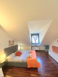 a bedroom with a bed with an orange chair at Casa Mirtillo in Turin