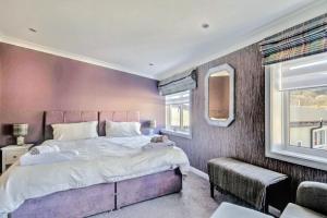 a bedroom with a large bed and a window at Thistle Apartment Golspie in Golspie