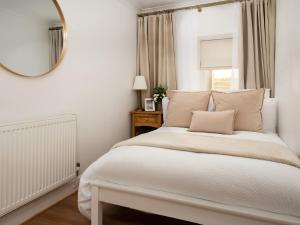 a bedroom with a large bed and a mirror at Beautiful Alnwick Apartment One in Alnwick