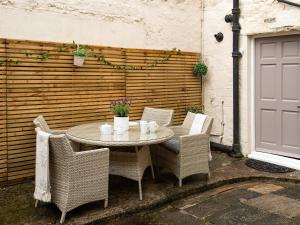 a table and chairs sitting on a patio at Beautiful Alnwick Apartment One in Alnwick